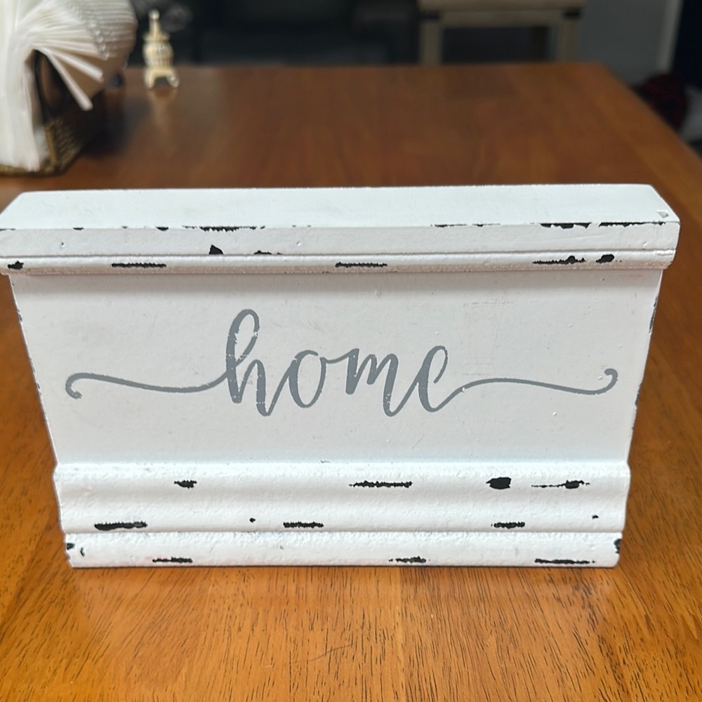 Quill to Paper wooden sign. White with gray writing. “Home”.